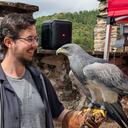 Michael Orsovszki holding a South American Grey Eagle